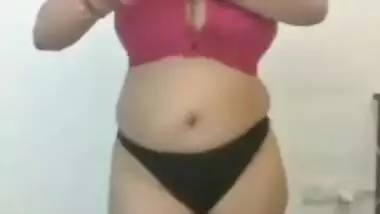 Full-bosomed Indian MILF unbuttons red bra to show her porn pomelos