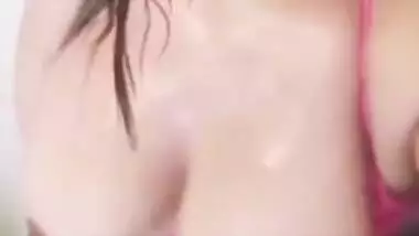 Desi woman with sexy pink lips focuses camera on succulent boobs